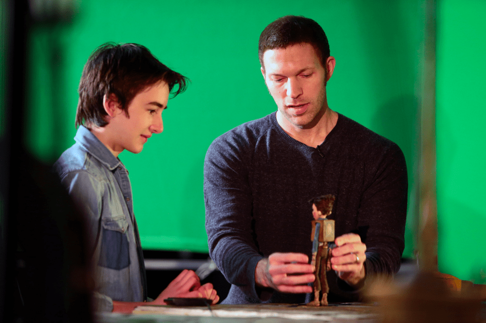 (L to R) Voice talent Isaac Hempstead-Wright visits with LAIKA CEO and Lead Animator Travis Knight during production of LAIKA and Focus Features' family event movie THE BOXTROLLS, opening nationwide September 26th. Credit: LAIKA, Inc.