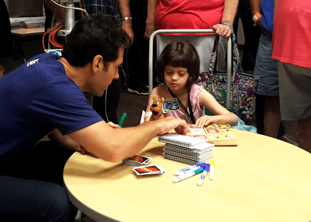 Paul Rudd being a REAL life Superhero by donating his time and playing with a girl named Abby Logan from Children's Mercy Hospital. This was during his Big Slick KC fundraiser.